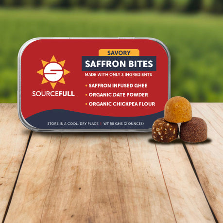 Sourcefull Saffron Bites packaging on a wooden surface with a green outdoor background